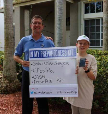 Dr. Rick Knabb with his son showing their Hurricane Prep Kit.